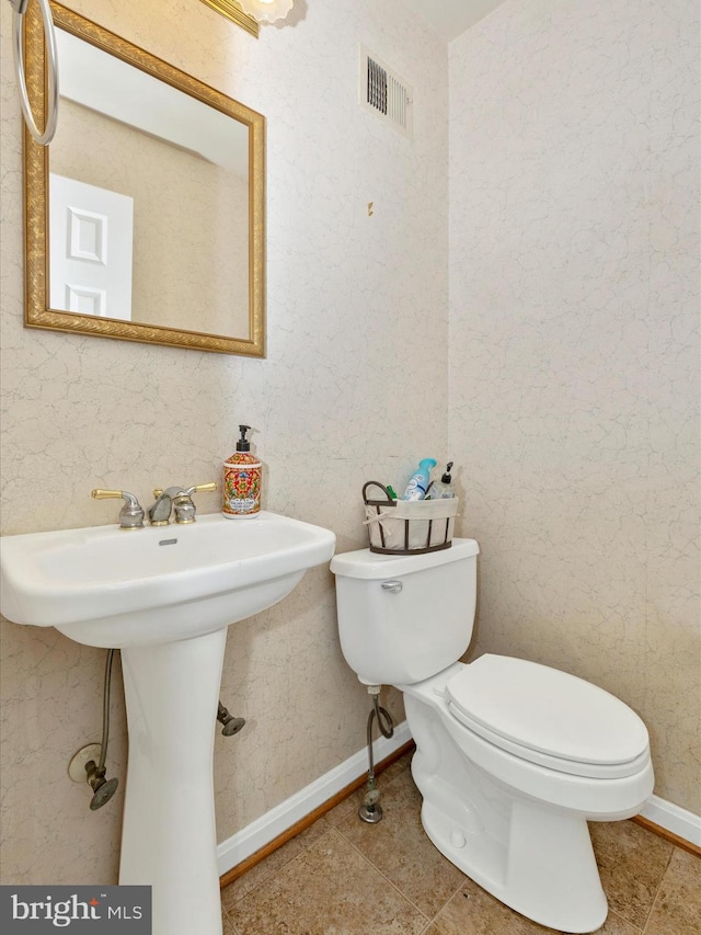 bathroom with tile patterned flooring and toilet