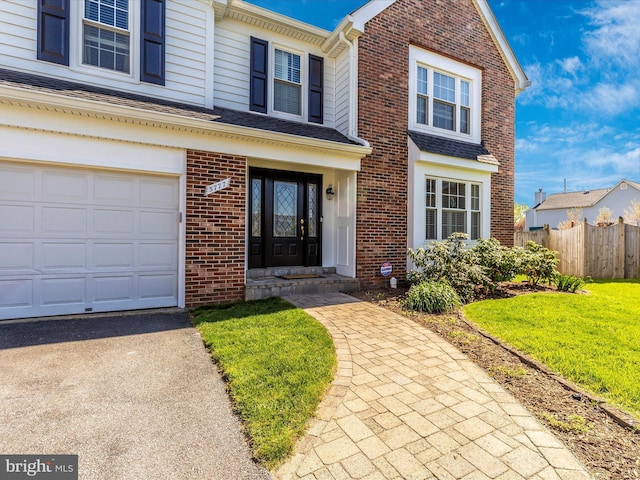 view of front of home with a garage and a front lawn