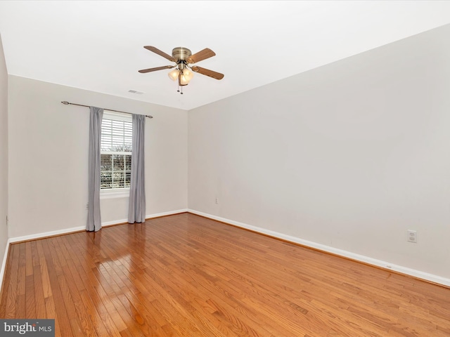 spare room with ceiling fan and light wood-type flooring