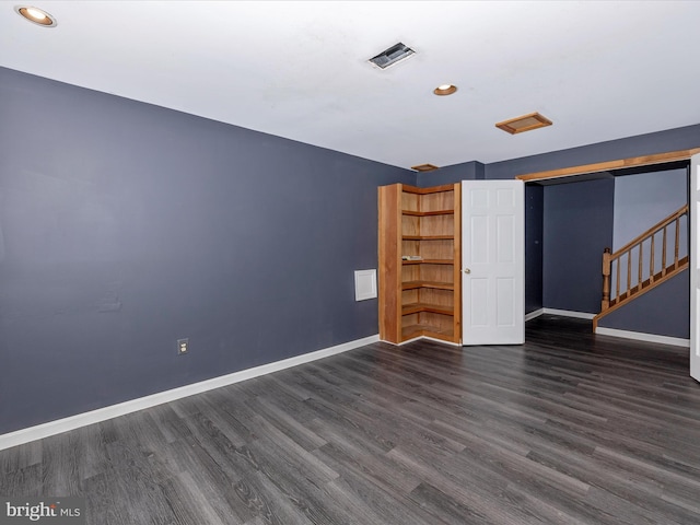 empty room featuring dark hardwood / wood-style flooring