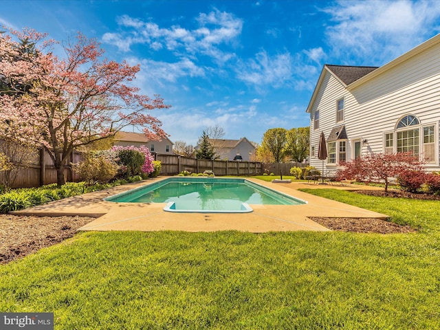 view of swimming pool featuring a yard and a patio area