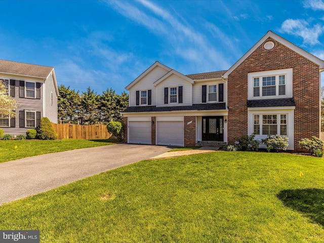 view of property with a garage and a front yard