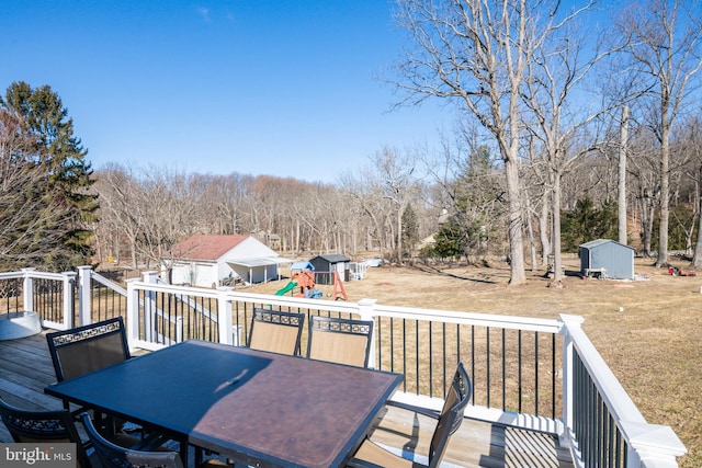 wooden deck featuring a storage unit and a playground