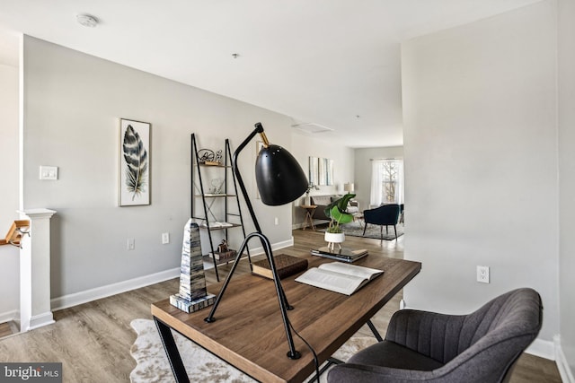 office space with wood-type flooring