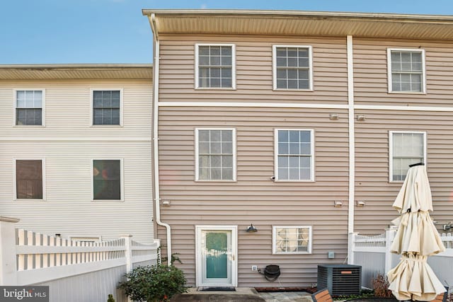 rear view of property featuring cooling unit