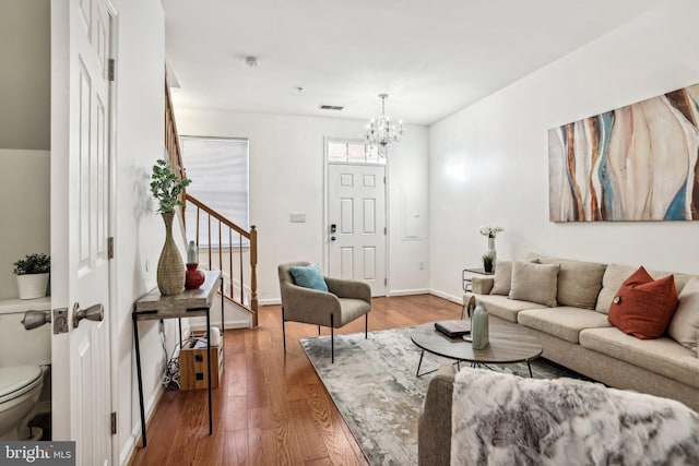 living room featuring an inviting chandelier and hardwood / wood-style floors