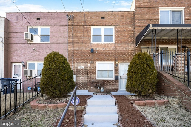 multi unit property featuring brick siding and fence