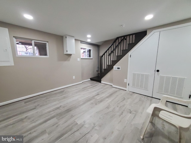 basement with light hardwood / wood-style floors