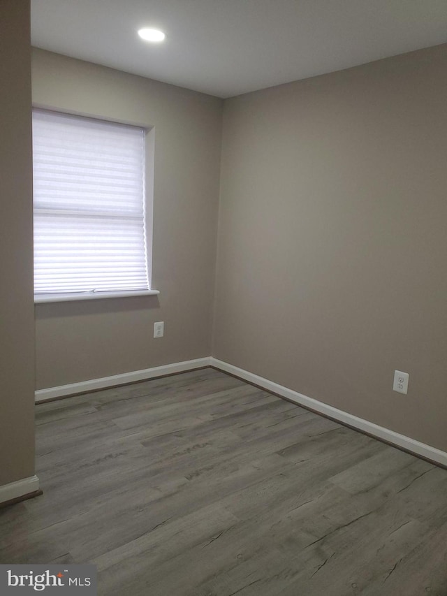 spare room with wood-type flooring