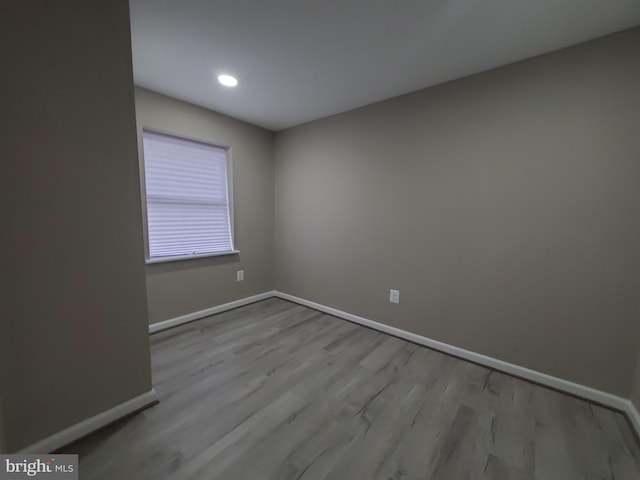 empty room with light hardwood / wood-style flooring