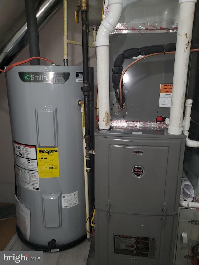 utility room featuring electric water heater and heating unit