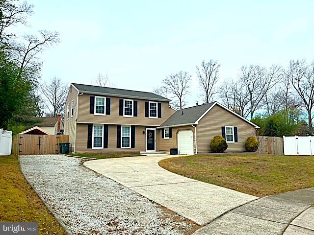 view of front facade with a garage and a front lawn