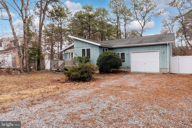 single story home with a garage and a deck