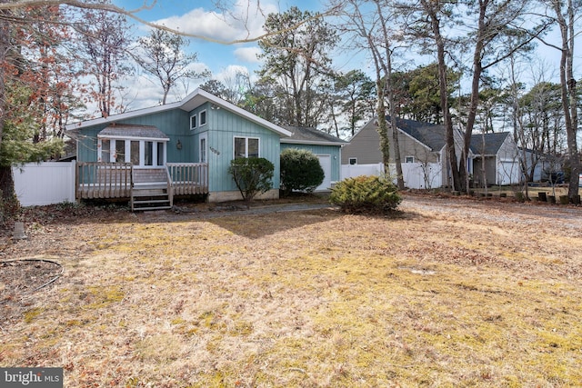 rear view of house featuring a wooden deck