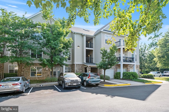 view of building exterior with uncovered parking