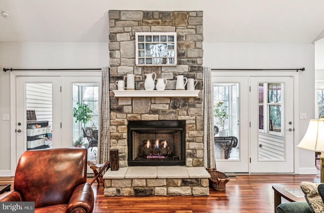 living room with hardwood / wood-style floors and a fireplace