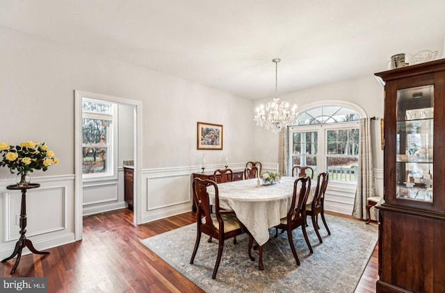 dining room featuring dark wood-type flooring and a notable chandelier