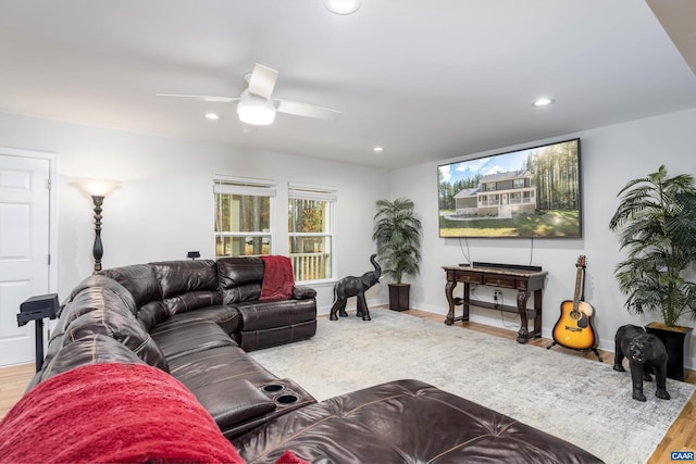 living room with ceiling fan and hardwood / wood-style floors