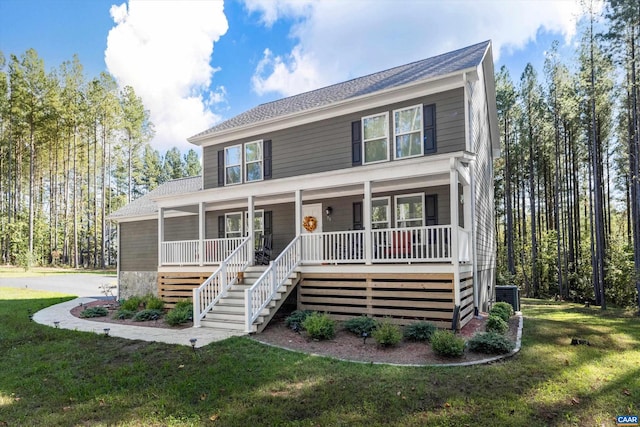 view of front of home featuring a porch, a front yard, and cooling unit