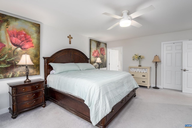 bedroom with ceiling fan and light carpet