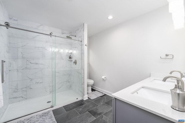 bathroom with vanity, an enclosed shower, and toilet