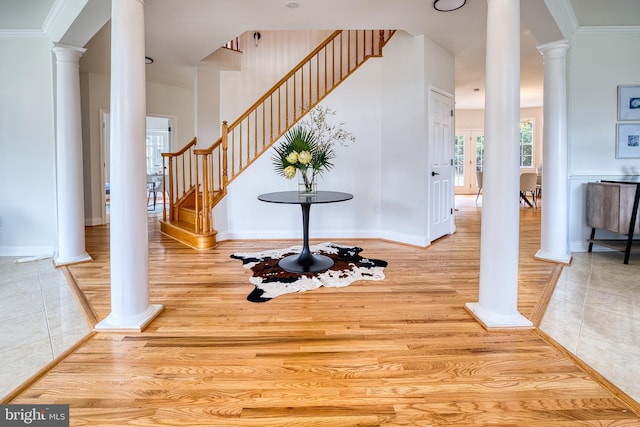 interior space with ornate columns, wood-type flooring, and crown molding