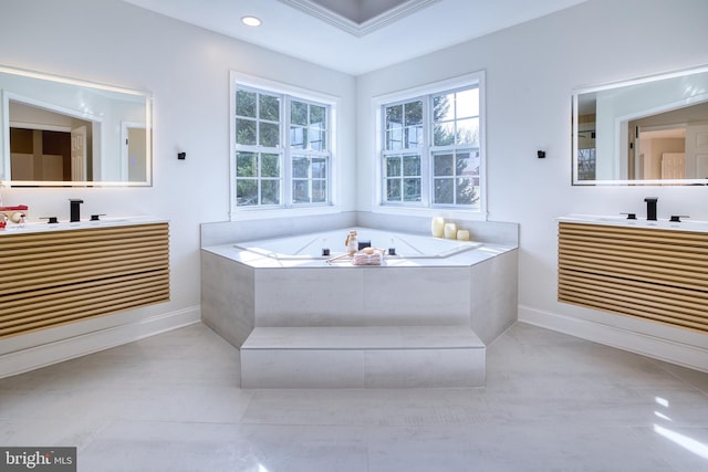 bathroom featuring vanity and a relaxing tiled tub