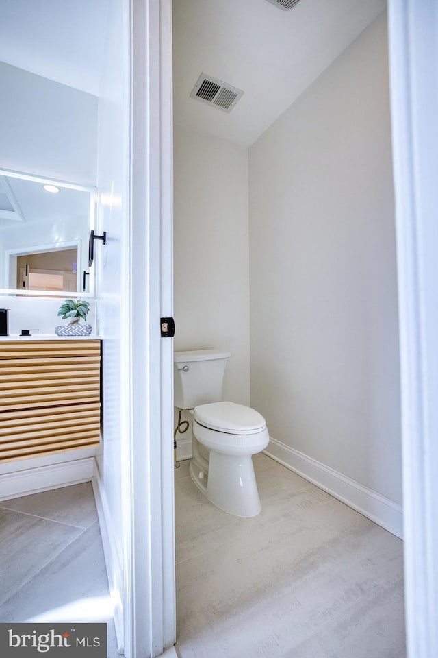 bathroom featuring wood-type flooring and toilet