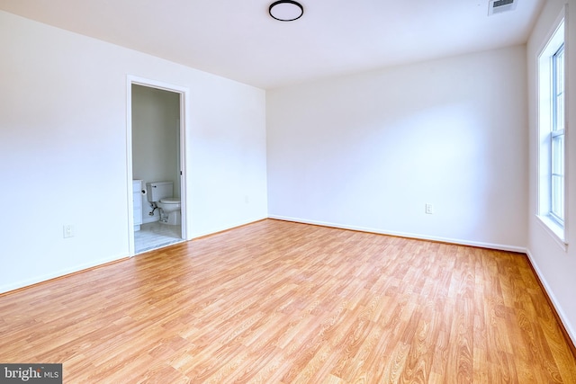 unfurnished room with light hardwood / wood-style floors