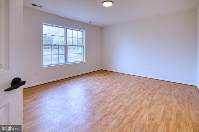 spare room with light hardwood / wood-style floors