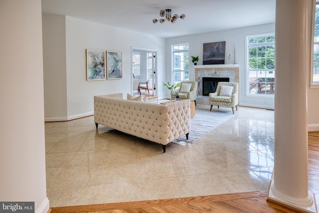 tiled living room featuring a chandelier and a tile fireplace