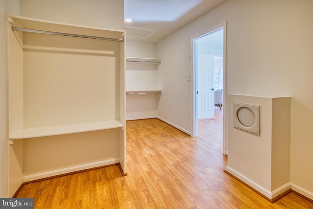 walk in closet featuring light hardwood / wood-style flooring