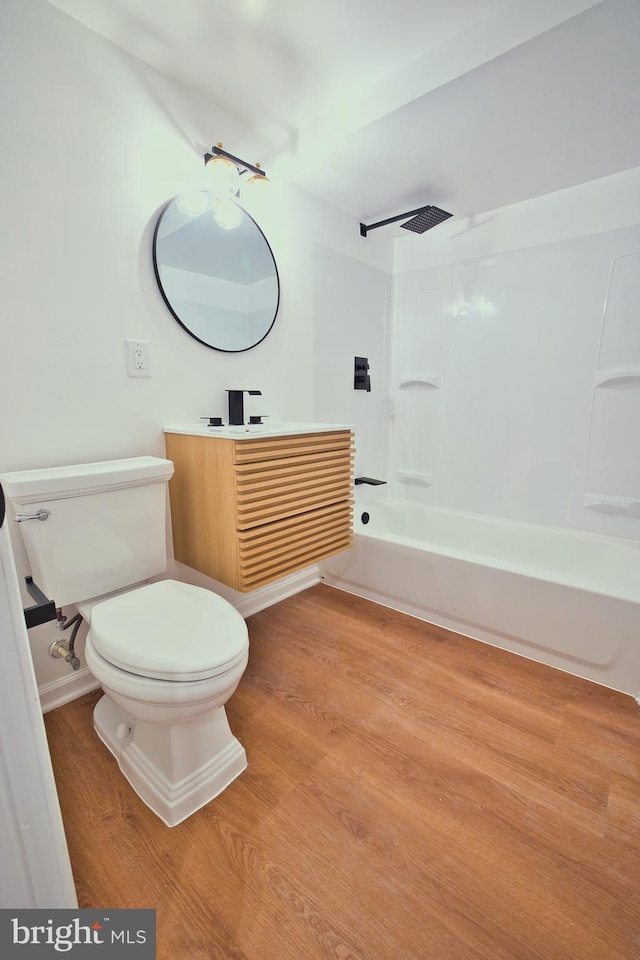 full bathroom featuring hardwood / wood-style flooring,  shower combination, vanity, and toilet