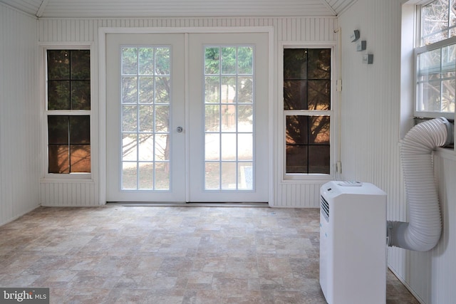 entryway featuring vaulted ceiling and french doors