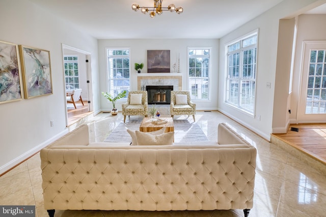 tiled living room featuring a notable chandelier