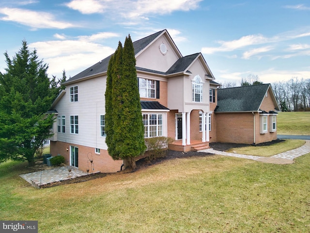 view of front facade with a patio area and a front yard