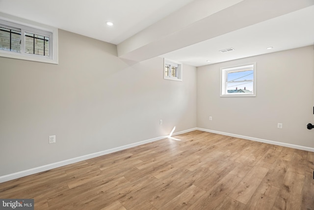 basement with light hardwood / wood-style floors