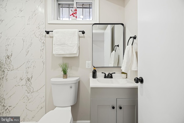 bathroom featuring vanity and toilet