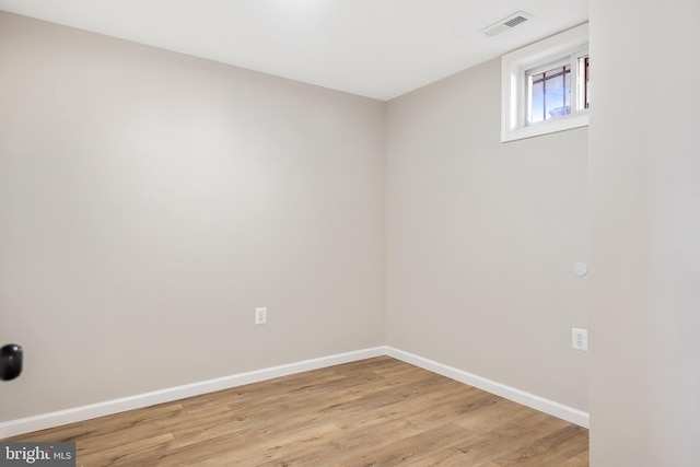empty room with light hardwood / wood-style flooring