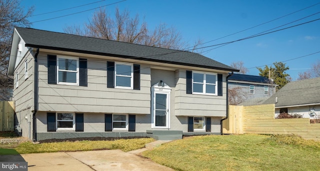 raised ranch featuring a front lawn