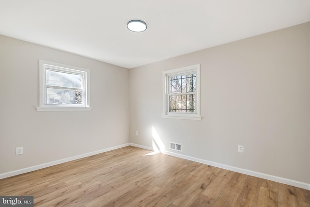 unfurnished room with light hardwood / wood-style floors