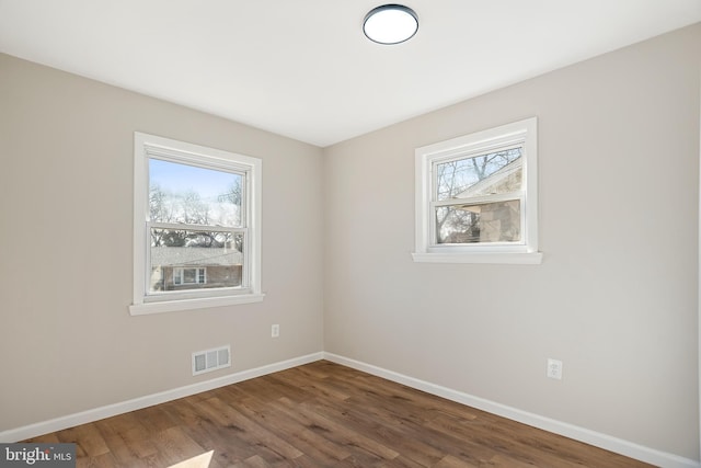 unfurnished room with dark hardwood / wood-style floors