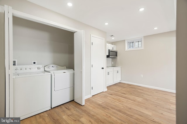 laundry area featuring separate washer and dryer and light wood-type flooring