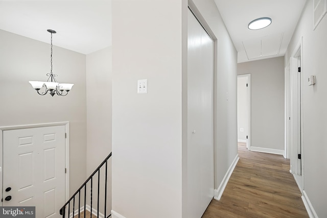 hall featuring dark hardwood / wood-style flooring and a notable chandelier