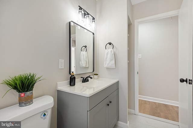 bathroom featuring vanity and toilet