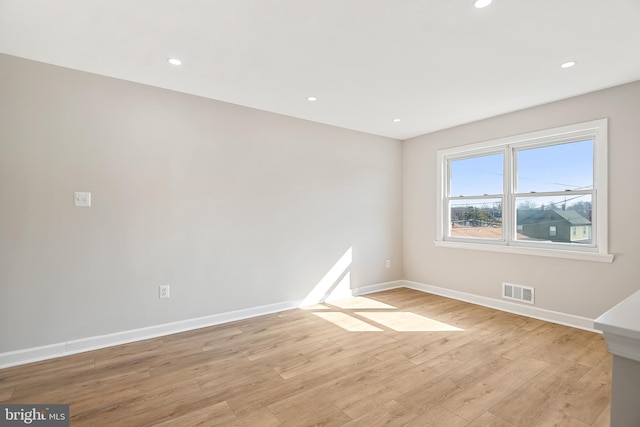 spare room with light hardwood / wood-style flooring