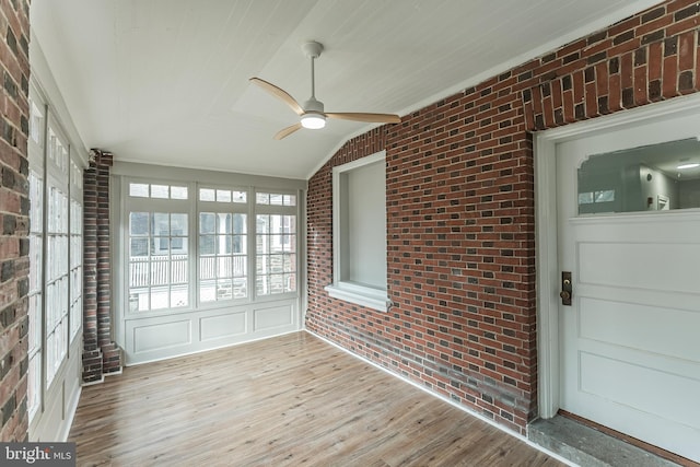 unfurnished sunroom featuring ceiling fan and vaulted ceiling