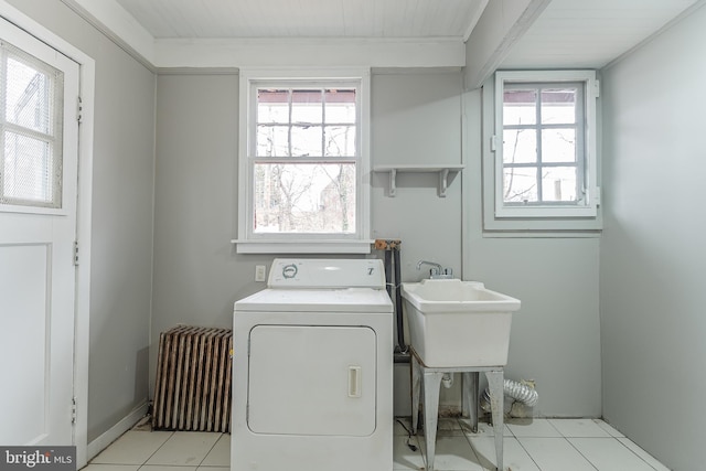 washroom with radiator, washer / dryer, and laundry area