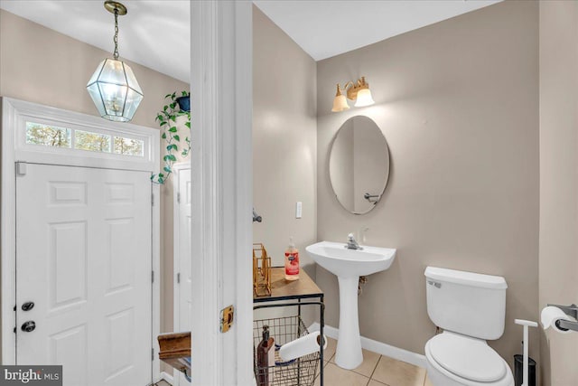 bathroom with tile patterned flooring and toilet