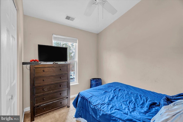 bedroom featuring light carpet and ceiling fan